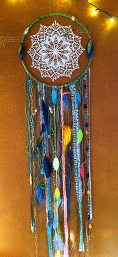 a decorative dream catcher hanging on the wall