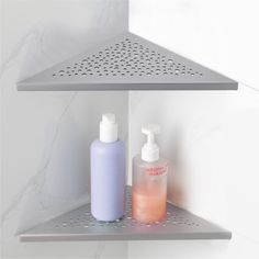 two bottles of soap and lotion sitting on a shelf