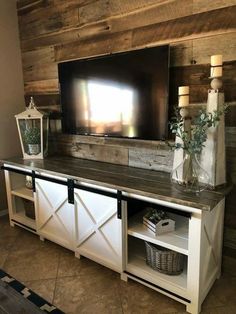 an entertainment center with a flat screen tv mounted above it