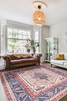 a living room filled with furniture and a rug