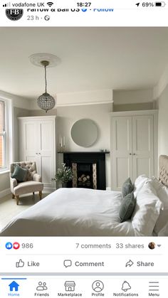 a bed room with a neatly made bed next to a fire place and a chair