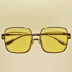 These 1970s vintage style sunglasses feature an oversized square lens, are outlined with a chic gold frame, provide UV 400 protection and comes in multiple colors. Each sold separately. Dimensions:  Length: 6 inches Lens diameter: 2.2 inches Gold Square Frame Sunglasses For Vacation, Gold Retro Sunglasses For Summer, Retro Gold Sunglasses For Summer, Gold Rectangular Sunglasses With Uva Protection, Gold Retro Summer Sunglasses, Vintage Gold Sunglasses For Summer, Gold Square Frame Sunglasses For Beach, Retro Gold Sunglasses For Beach, Retro Gold Sunglasses With Uv Protection