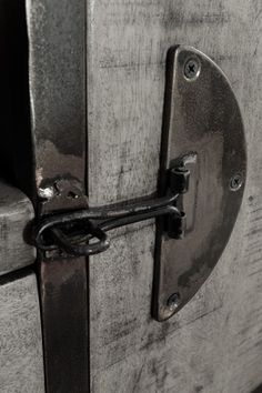 an open door with a metal handle on the front and side of it that is made out of wood