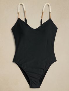 One-piece swimsuit featuring elastic cord and resin details on the straps.  The adjustable parallel straps and back neckline ensure a customized fit, and with removable padded cups, it combines comfort and style seamlessly.  This one piece doubles as a bodysuit and can be styled casually with your favorite pair of jeans.  SWIMWEAR: Beloved for luxurious touches—like touches of leather and 24K gold-plated hardware—Paula Hermanny launched Swimwear in the United States in the early 2000s, designing hand-crafted pieces, inspired by Brazilian beach culture, for women who appreciate beauty, quality and attention to detail.  Elastic cord details Resin accents 24k gold-plated details Adjustable shoulder straps Fully lined Made in Brazil Brazilian-style high-cut legs, cheeky fit at back.  S: Bust 3 Hawaii Bikinis, Black Monokini, Bathing Suits One Piece, Swimsuit Trends, Safari Style, Fashionista Clothes, Swimsuits For All, Black Swimsuit, Swimwear Fashion