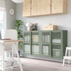 a green cabinet sitting next to a white chair