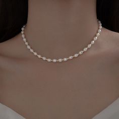 Indulge in the timeless elegance of our Pearl Necklace Choker, a delicate piece that exudes grace and sophistication. Crafted with small natural pearls and set on a dainty 925 Sterling Silver chain, this necklace is the epitome of understated luxury. Perfect for bridesmaids or as a bridal accessory, this necklace adds a touch of refined beauty to any wedding ensemble. Its trendy choker style effortlessly complements modern bridal looks, making it a versatile addition to your jewelry collection. Pearl Necklace Choker, Trendy Chokers, Natural Pearl Necklace, Bridal Accessory, Understated Luxury, Modern Bridal, Wedding Bridal Jewellery, Choker Style, Natural Pearl