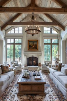 a living room filled with furniture and a fire place in the middle of an open floor plan