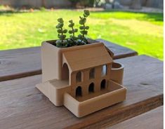 a house planter sitting on top of a wooden table