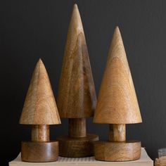 three wooden toy trees sitting on top of a table