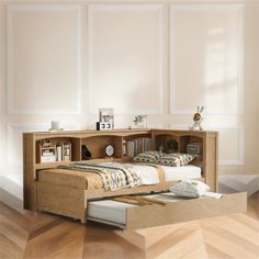 a bed sitting in the middle of a room next to a book shelf filled with books