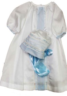 "This exquisite boy satin batiste heirloom baby gown, slip, and bonnet set is perfect for special occasions like Easter, coming home from the hospital, and infant's first pictures. Handmade with the finest cotton materials like cotton Satin batiste, French Valenciennes lace, and entredeux, this gown set exudes elegance and style. The center panel of the gown features delicate ivory hand feather stitching with blue Swiss batiste framing and Mother of Pearl buttons. The slip, also made with white Angel Baby Clothes, Baby Boy Coming Home Outfit, Boy Coming Home Outfit, Baby Easter Outfit, Baby Coming Home Outfit, Boys Day, Feather Stitch, Shell Stitch, Heirloom Sewing