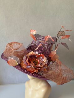 Liana climbs high in beautiful lilac purple and pink metallics. Woven design set on a straw base with beautifully sculpted floral accents makes this hat an over the top stand out piece. Kentucky derby church hat is perfect for any special occasion or event. Inside features elastic headband to allow for a comfortable and adjust able fit. Floral arrangement can be worn to the side or front and center. All designs are made by hand with no two identical. Custom requests are accepted!  This custom straw hat sculpted and designed by milliner, Alyssa Clarenson.  Hat is 18Length x 18 Width x 10" height. * Please note, due to special nature of product and health and safety concerns, returns are not accepted. All items shipped with tracking and insurance, if there is ever an issue, please contact me Purple Mini Hat With Curved Brim For Kentucky Derby, Purple Curved Brim Mini Hat For Kentucky Derby, Purple Hat With Short Brim For Royal Ascot, Purple Short Brim Hat For Royal Ascot, Purple Wide Brim Hat For Races, Purple Wide Brim Hat For Spring, Handmade Purple Party Hat, Purple Fedora Hat For Party, Lavender Adjustable Hat For Kentucky Derby