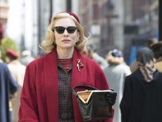 a woman with sunglasses and a red coat