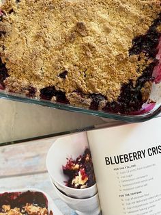 a blueberry crumble on top of an open cookbook