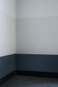 an empty room with black and white walls