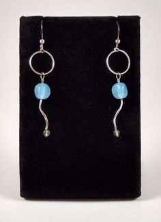 Blue quartz and peridot on Sterling Silver swirl and hoop earrings. The 22 gauge earwires are approximately one inch in length. The drops are approximately 1.5 inches in length. Modern Twist Dangle Earrings With Ear Wire, Blue Small Hoop Earrings Wire Wrapped, Blue Small Hoop Earrings With Wire Wrapping, Nickel-free Spiral Blue Earrings, Nickel-free Modern Twist Dangle Earrings, Nickel-free Dangle Earrings With A Modern Twist, Modern Twist Nickel-free Dangle Earrings, Blue Sterling Silver Wire Wrapped Hoop Earrings, Blue Wire Wrapped Sterling Silver Hoop Earrings