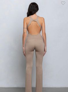 A simple soft to touch jumpsuit. Stretchy but fitting. Double lined fabric. Zips down front. Halter with a v neck. Straight leg. Pair with a luxe heel.95% modal 5% spandex. Model is wearing a small. 33 inseam. To Touch, Top Sales, Swimwear Tops, Jumpsuit Dress, Straight Leg, Jumpsuit, Spandex, V Neck, Heels