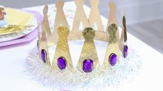 a purple and gold crown sitting on top of a table