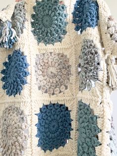 a crocheted blanket with blue and white squares