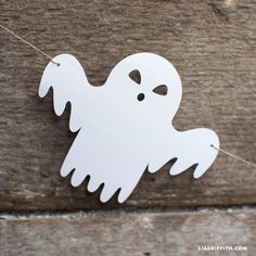 a white paper ghost hanging on a string