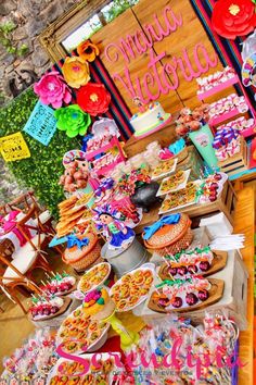 a table filled with lots of different types of food and desserts on top of it