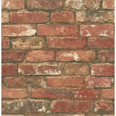 an old red brick wall with peeling paint