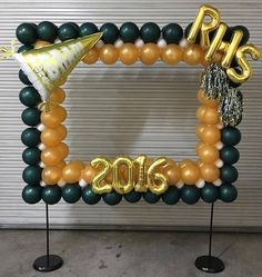 a balloon arch with balloons and streamers on it for a new year's eve celebration