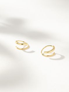 Get double the impact with minimal hardware. Our Seeing Double Earrings spiral around for a unique look that you only need one ear piercing for. These Sterling Silver or gold spiral earrings give you both a studded look and a delicate look — what more could you ask for? | Gold Seeing Double Spiral Hoop Earrings | Women's Jewelry by Uncommon James Gold Hoop Double Piercing, Double Twist Earrings, Spiral Double Earring, Minimalist Spiral Hoop Earrings, One Ear Piercing, Modern Spiral Hoop Earrings (single), Uncommon James, Seeing Double, Double Earrings