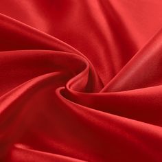 a red satin fabric with very thin lines on the bottom, and small folds in the middle