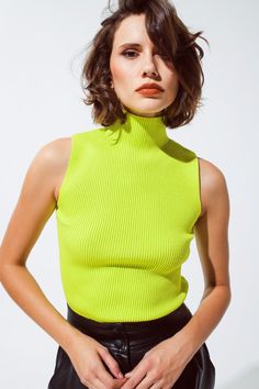 Introducing our Knitted Lime Green Top with a Chic High Neck and Sleeveless Design – a stylish and versatile addition to your wardrobe, perfect for creating fashionable outfits.   Key Features:     Material:  Crafted from a blend of 55% Viscose and 45% Polyamide, this lime green top offers a fine and comfortable knit.   Sleeveless Design:  This top features a sleeveless style, making it versatile for layering under blazers or cardigans.   High Neck:  The high neck adds a touch of elegance and style to your outfit.   Bodycon Fit:  Designed for a body-hugging fit, it enhances your silhouette for a chic and fashionable look.   Turtleneck Neckline:  The turtleneck neckline adds warmth and style to your ensemble, suitable for various occasions.   Fit:  Model is wearing size S. Model is: 32-23-3 Top Without Sleeves, Sleeveless Turtleneck Top, Verde Lima, Sleeveless Knit Top, Sleeveless Turtleneck, Turtleneck Top, Professional Look, Green Tops, Tailored Trousers