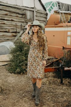 Introducing The Nellie Dress - the perfect fall dress with a midi length that flatters any figure. The charming falling leaf color print adds a touch of nature and the sweetheart neckline and elastic cuffs add a touch of elegance. This western dress is a must-have for your closet! Haylee is wearing size medium paired with Jukebox Boot and Felt Cowboy ProHat Brown Knee-length Midi Dress For Fall, Fall Floral Print Knee-length Midi Dress, Fall Floral Print Midi Dress, Modest Floral Print Midi Dress For Fall, Modest Floral Print Dress For Fall, Knee-length Floral Print Midi Dress For Fall, Mid-length Floral Print Midi Dress For Fall, Floral Print Mid-length Midi Dress For Fall, Brown Floral Print Midi Dress For Fall