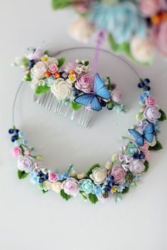 a hair comb with flowers and butterflies on it next to a flowered headband