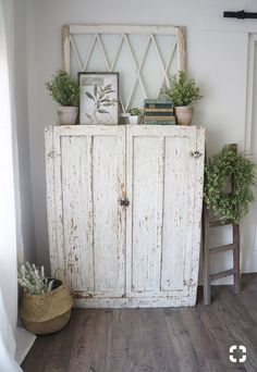 an old white cabinet with potted plants on top is featured in the article how to decorate the top of an armoire