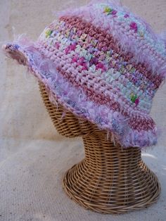 This lovely  Spring decorative romantic hat is hand crocheted (by me) of pink, rose, white and mohair yarns, with little silver sparkly balls scattered along the brim, which flares out a bit.  To me, it definitely  is reminiscent of a rose garden and a birthday cake -- very happy!  It is of medium size and 8 1/2 inches long.  The yarns are mainly synthetic. Whimsical Pink Bucket Hat, Bohemian Pink Crochet Hat For Spring, Handmade Pink Yarn Mini Hats, Handmade Whimsical Pink Mini Hats, Whimsical Pink Handmade Crochet Hat, Whimsical Handmade Pink Crochet Hat, Cute Pink Crochet Bucket Hat, Whimsical Pink Hand-knitted Crochet Hat, Pink Spring Crochet Hat