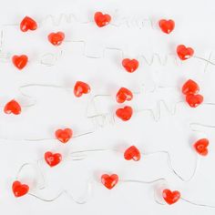 there are many red hearts in the shape of letters and numbers on this white surface