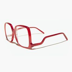 A hybrid of granny-chic and Farrah Fawcett foxiness, the candy-red Mia boasts a bold, oversized frame that belies its lightweight fit.  Upside-down temples support the chunky frame to complete the retro 70s vibe.  Choose from five far-out colors.  Available as a bifocal or reader.   Aspheric Lenses handmade using acetate material RX optical quality FIT INFORMATION 55mm eye size 18mm bridge 140mm temple/arm Width 5 1/2 inches Height 2 1/4 inches  International Buyers Please Note:  *Import duties, 70s Glasses, Glasses Inspiration, Big Glasses, Funky Glasses, Bifocal Glasses, Oversized Glasses, Candy Red, Red Glasses, Cool Glasses