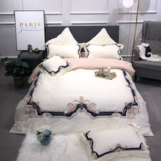 a bed with white and blue comforters in a room