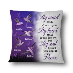 a pillow with words on it and birds flying over the ground in front of them