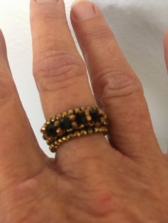 This is a beaded ring made out of bronze seed beads and black crystal bicones.  It is a size 7.5 Beaded Ring, Beaded Rings, Black Crystals, Stackable Rings, Favorite Things Gift, Labour Day, Seed Beads, Jewelry Rings, Accessory Gift