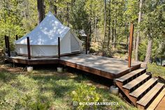 a white tent sitting on top of a wooden platform