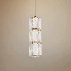 a light fixture hanging from a ceiling in a room with beige walls and flooring