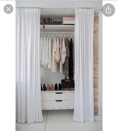 an open closet with white curtains and shoes