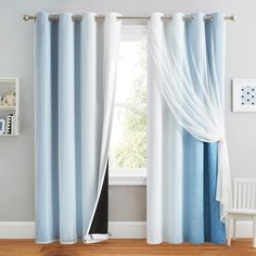 the curtains are hanging in front of a window with blue and white drapes on it