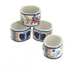 four ceramic bowls with floral designs on them