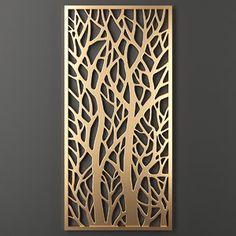 a metal wall hanging on the side of a gray wall with trees cut out of it