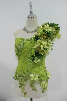 a green dress with flowers on it