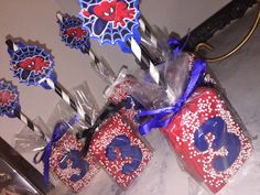 some red, white and blue cupcakes on sticks with spiderman toppers