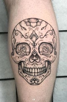 a man's leg with a skull tattoo on it