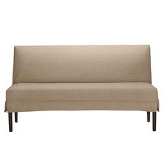 a beige couch sitting on top of a wooden frame