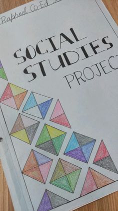 a book with the title'social studies project'written on it and colored paper